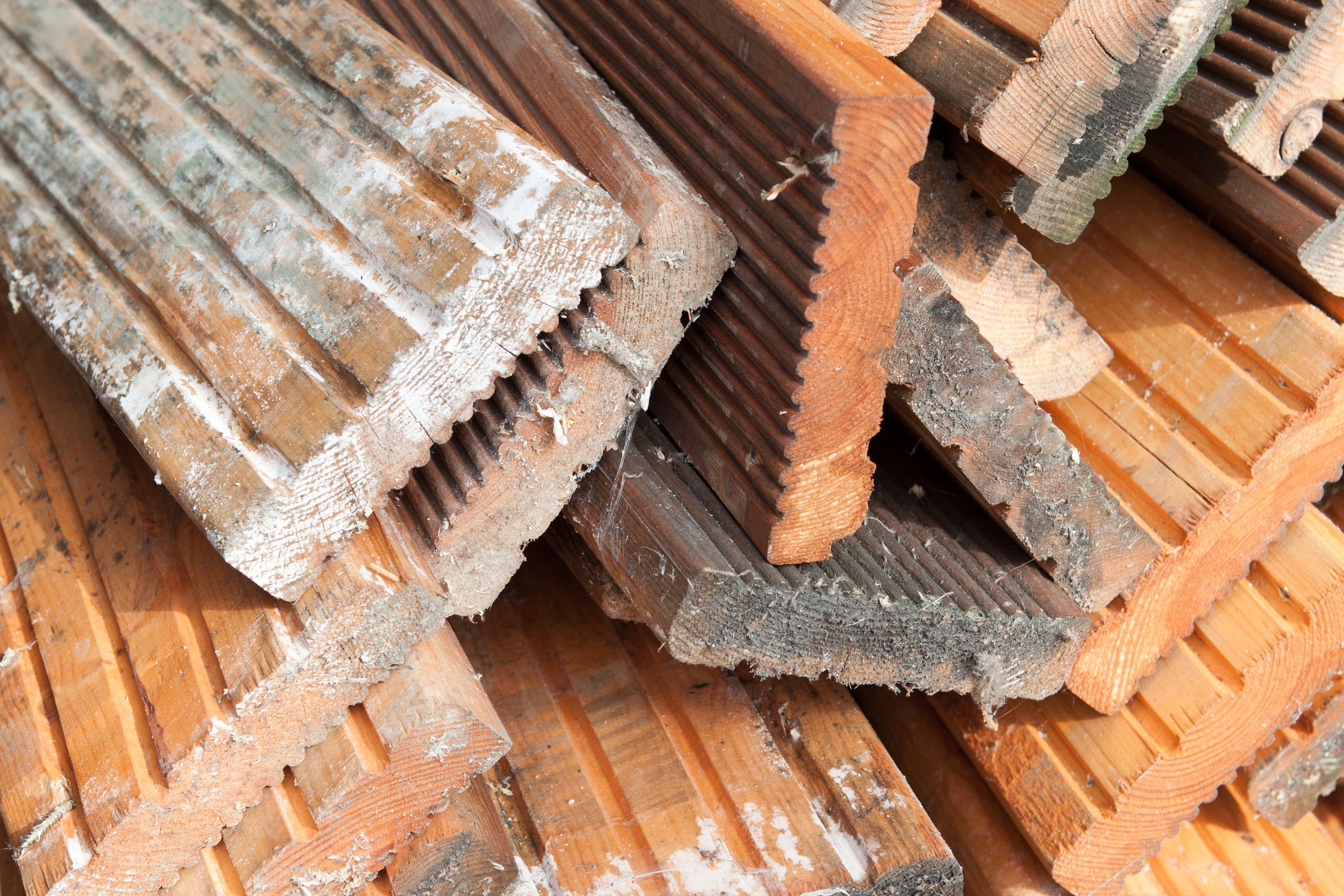 A stack of rusted wood planks, highlighting the wood mold removal service available in Vancouver, WA.