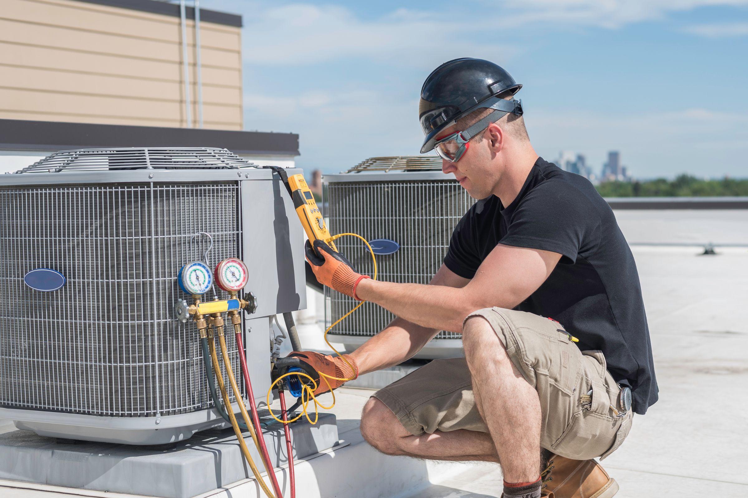 A man engaged in air conditioning unit maintenance for HVAC mold removal in Vancouver, WA.